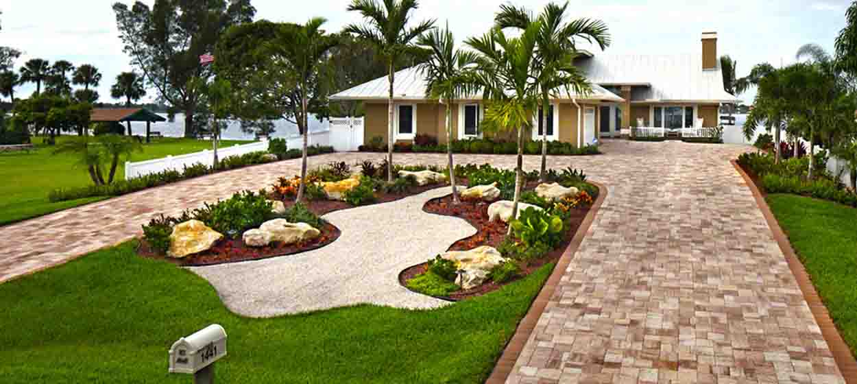 Terracotta-blend paver driveway with landscaped island, Central Florida